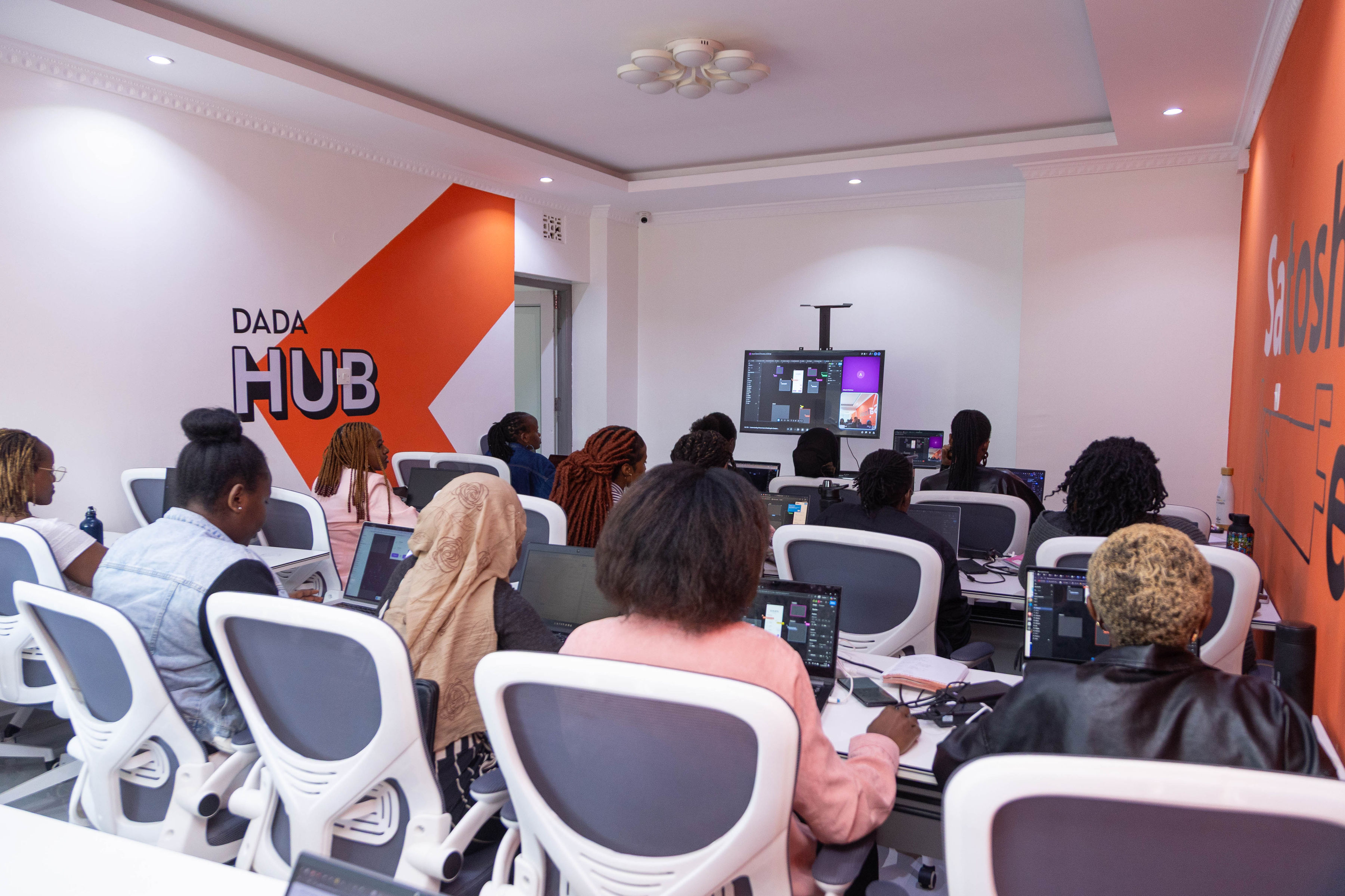 Audience seated at Dada Hub, seen from the back of the room